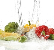 Vegetables with  splashing water on white background